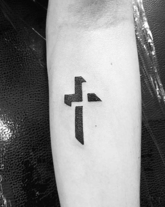 minimalist cross tattoo in black