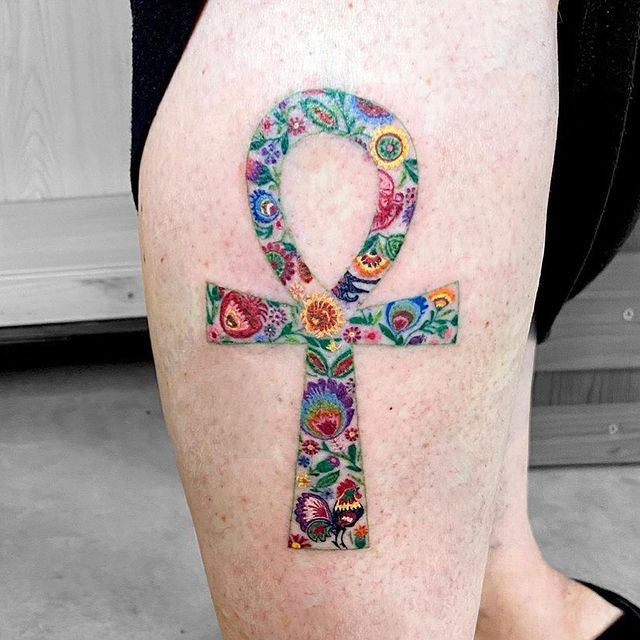 vibrantly color ankh tattoo on the arm